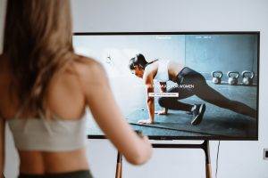 Woman selecting a full-body strength training workout from a streaming fitness platform